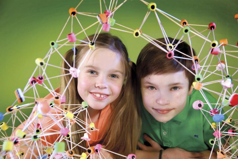 two children looking at an architectural project