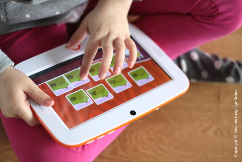 Child using a tablet with colourful pictures